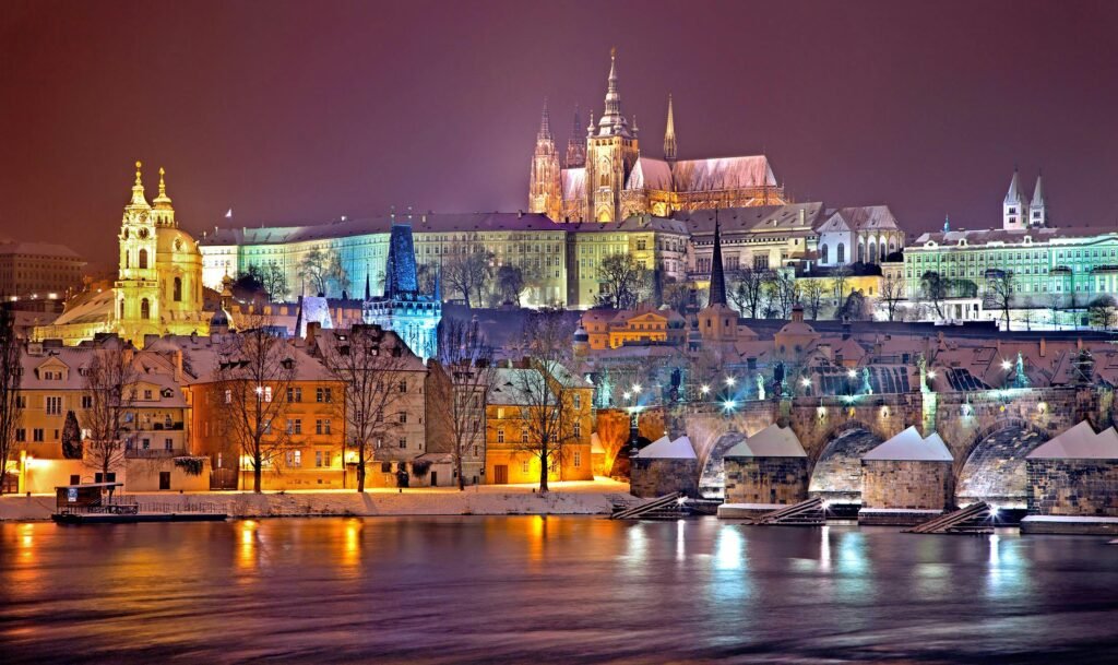 Illuminated Prague Castle and Vltava River at night in winter. Capturing historic beauty.